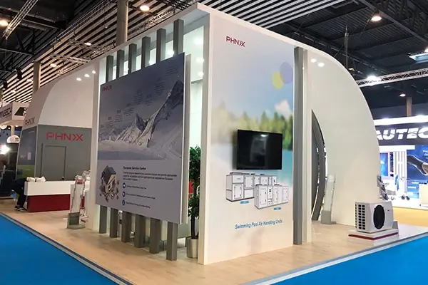 PHNIX trade show booth featuring product displays, presentation panels, meeting area, and modern exhibition design
