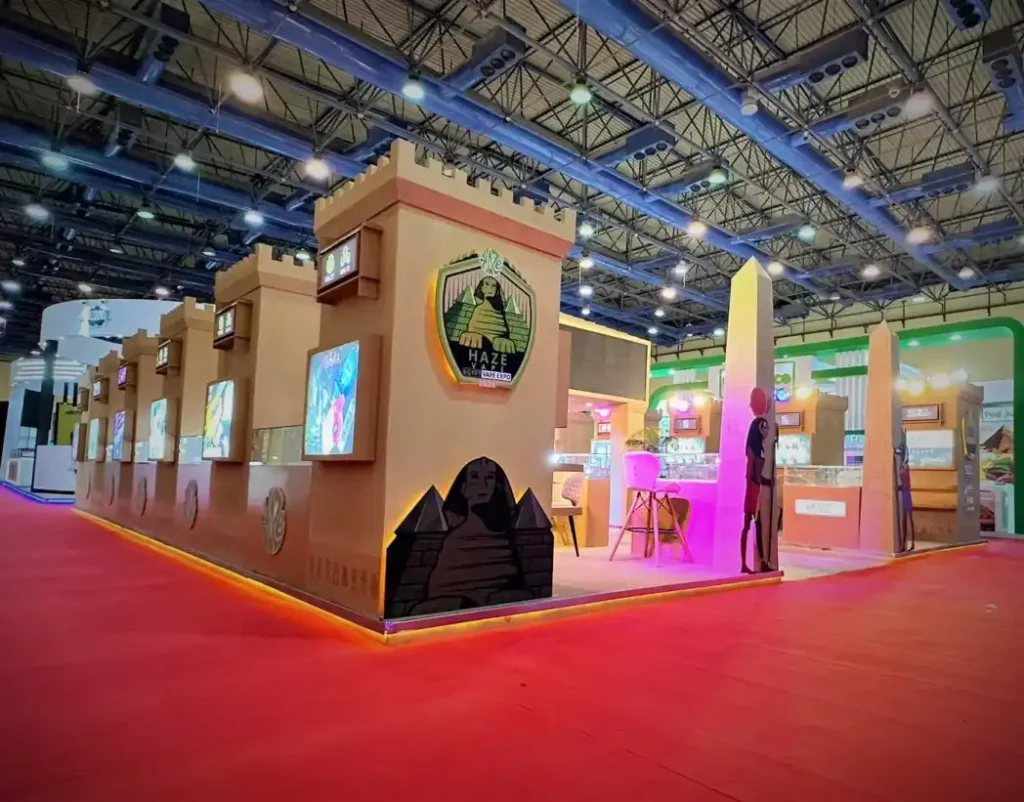 Comfortable lounge seating area inside a trade show booth with product display walls