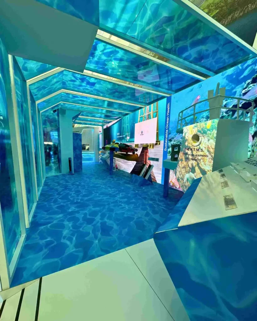 Immersive exhibition stand walkway with underwater themed interactive event setup