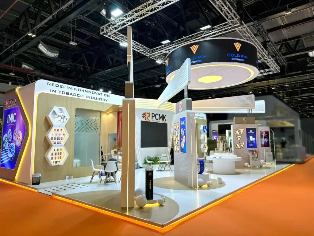 Corner view of PCMK Industries trade show booth with illuminated product display structures