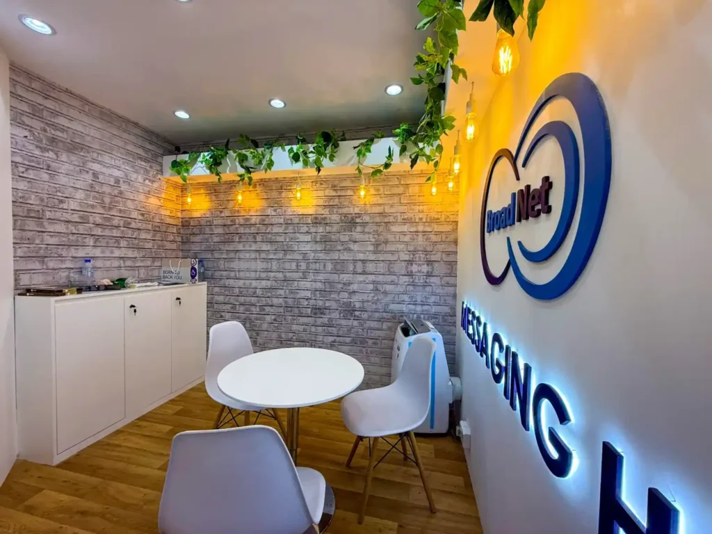 Broad Net exhibition booth featuring messaging center displays and illuminated ceiling feature