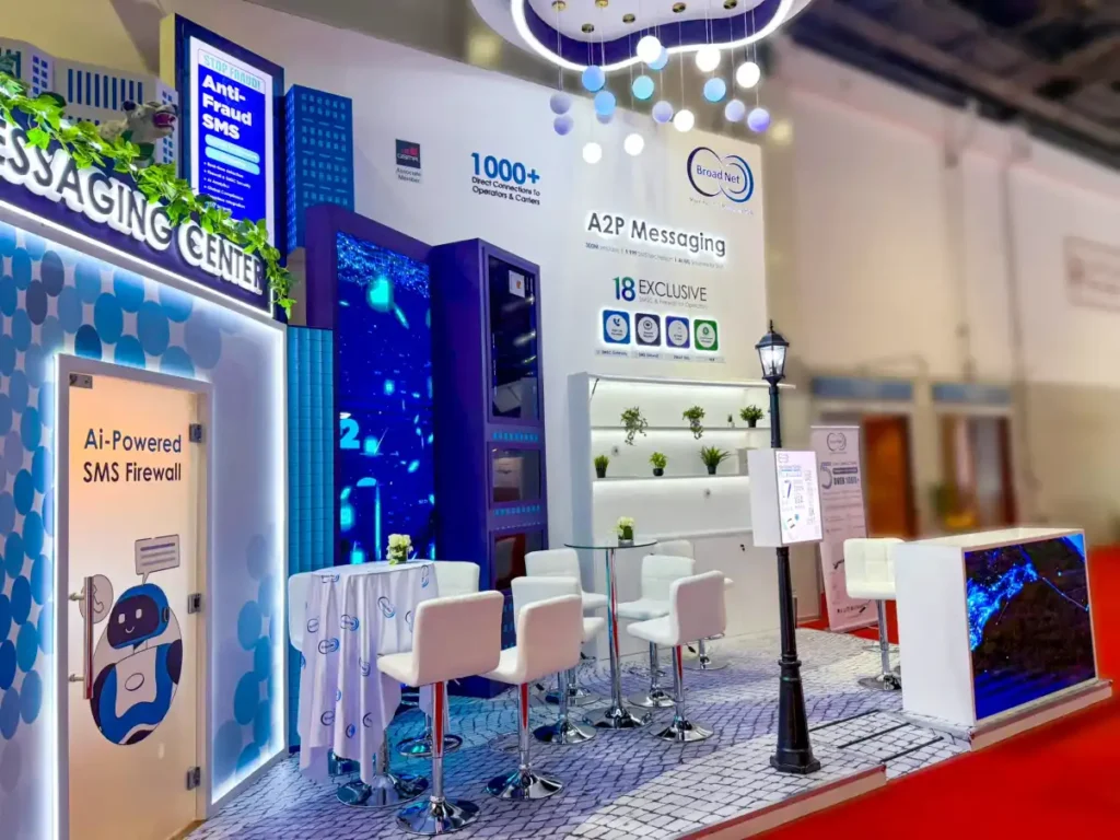 Broad Net trade show booth featuring digital screens and white meeting chairs