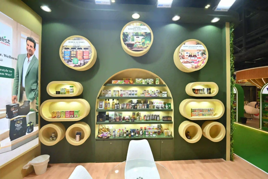 Custom exhibition stand interior with illuminated shelves and circular product display niches