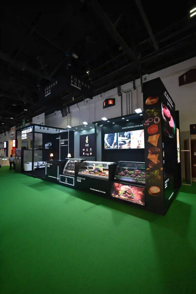 Forsan Pro exhibition booth featuring refrigerated displays, digital screens, and branded panels