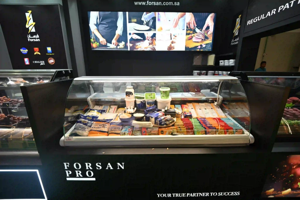 Forsan Pro exhibition stand displaying packaged food products inside a refrigerated showcase.