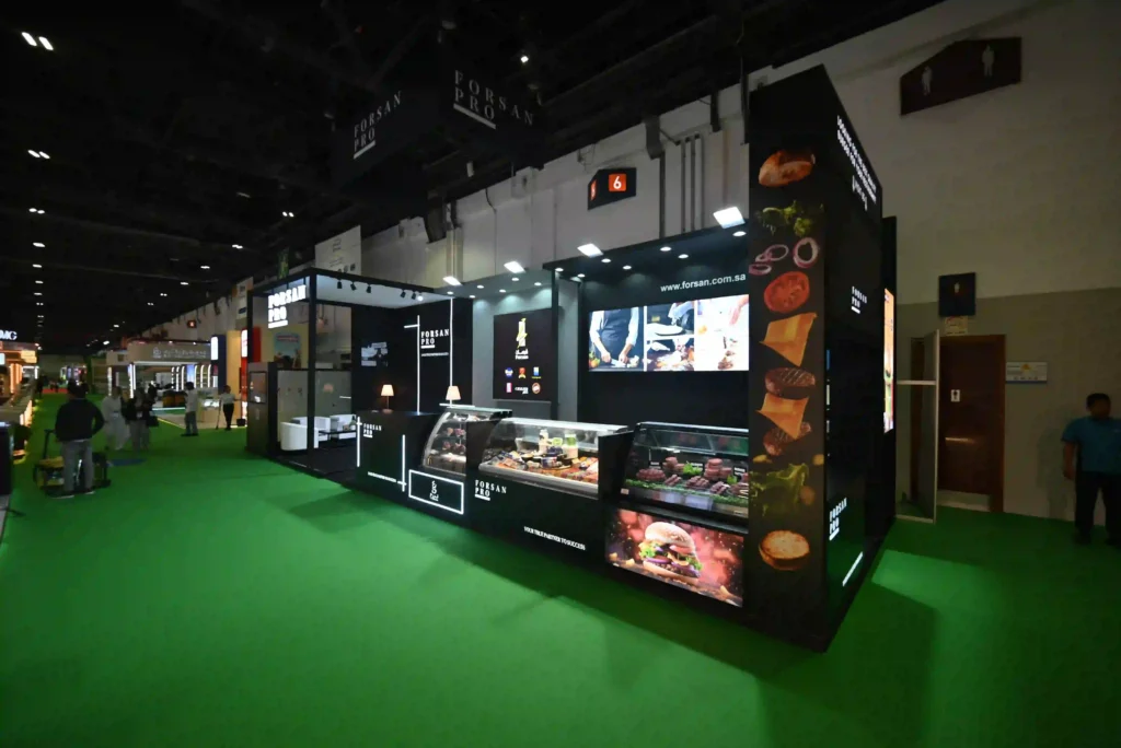 Forsan Pro trade show booth featuring refrigerated food product display counters
