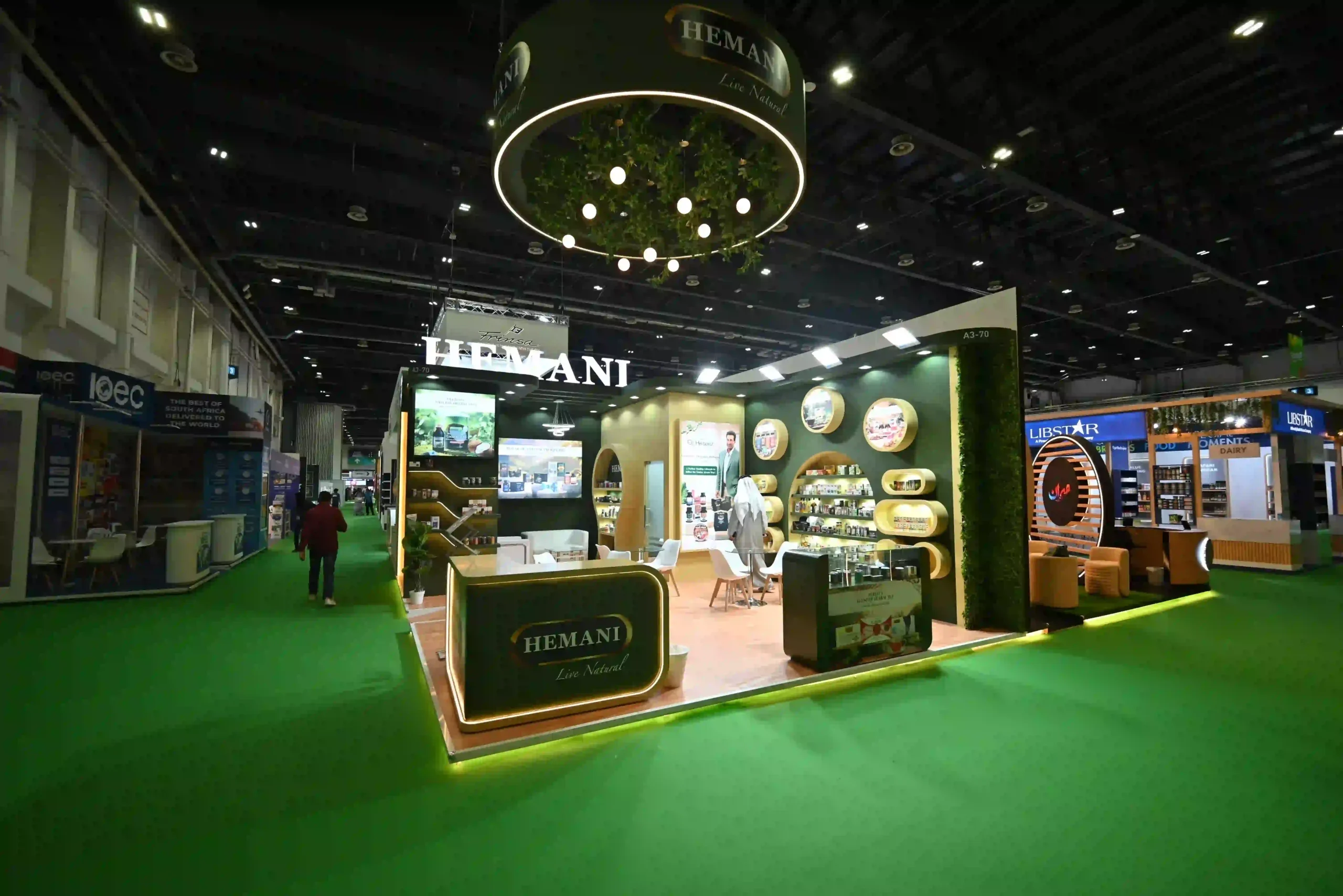 Hemani custom exhibition stand at a trade show featuring illuminated product displays