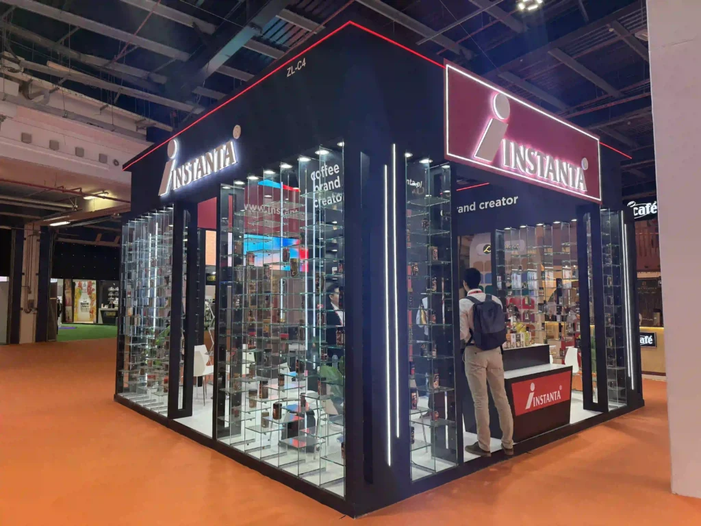 Instanta custom exhibition stand with glass showcases and branded reception area