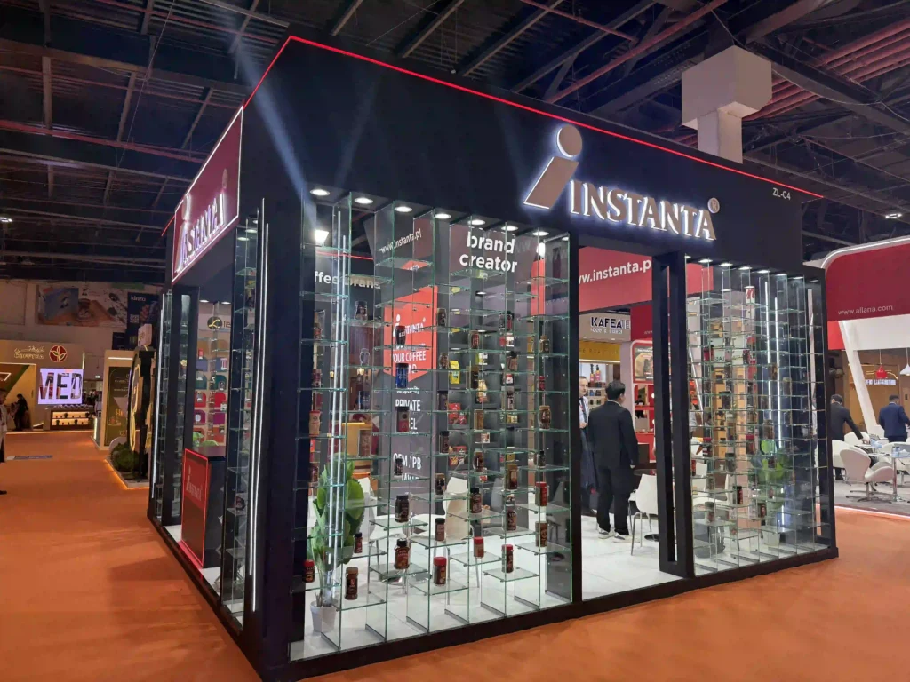 Instanta trade show booth featuring glass product displays and illuminated branding