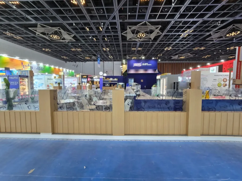 Wide view of custom exhibition booths at an international dairy trade show