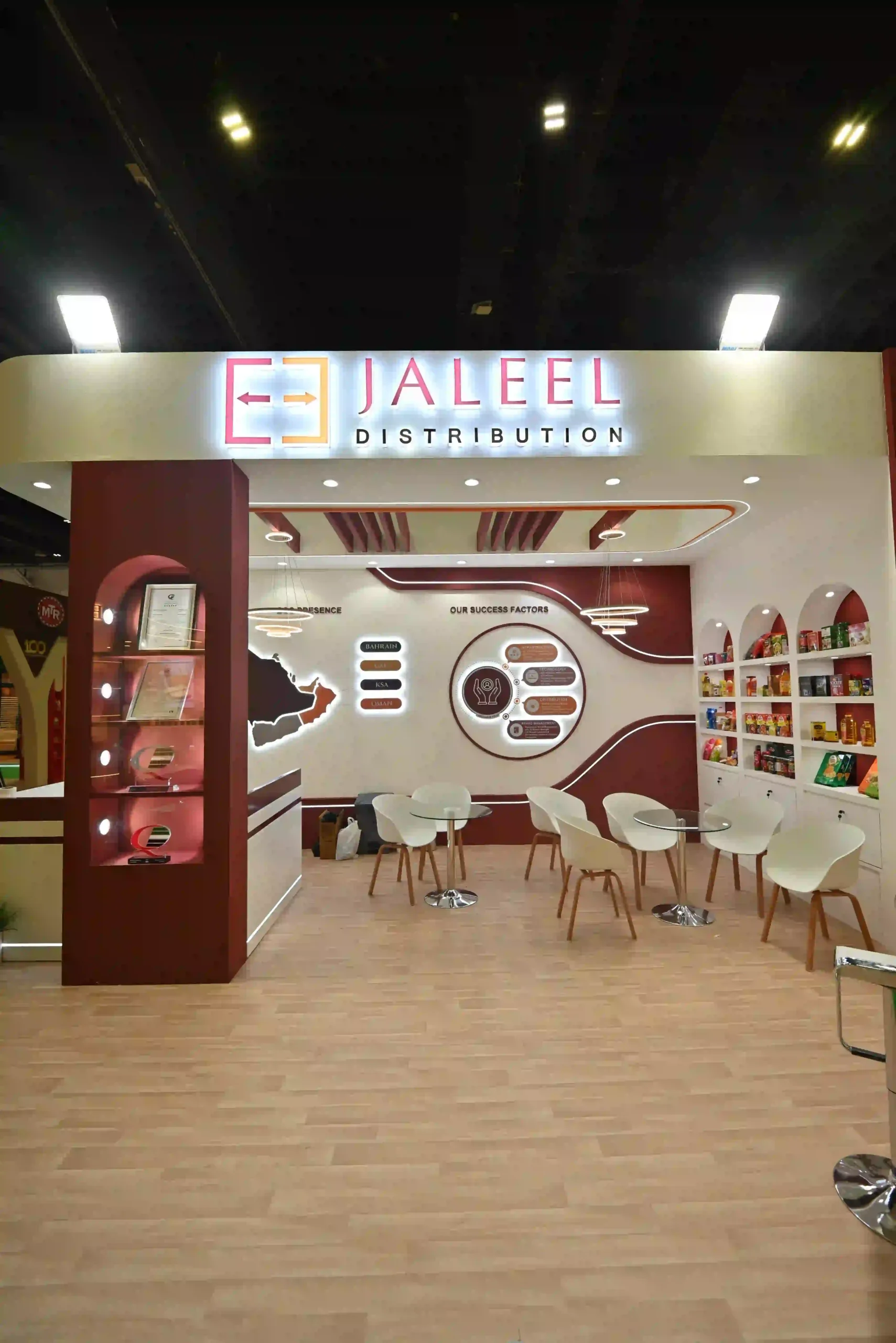 Jaleel Distribution exhibition stand interior featuring seating area and branded product displays