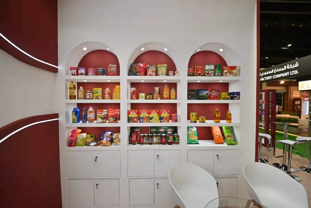 Product display shelves showcasing packaged goods inside Jaleel Distribution exhibition booth