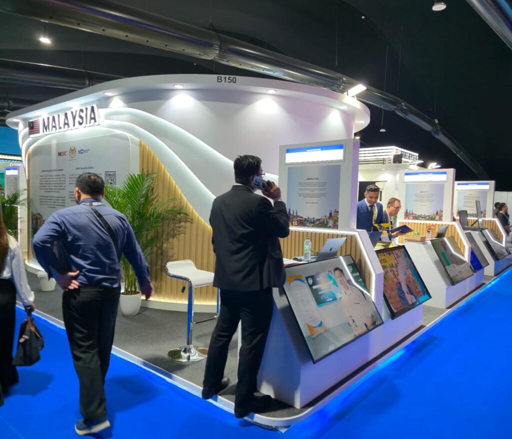 Malaysia Digital custom exhibition stand featuring interactive displays and illuminated curved architecture