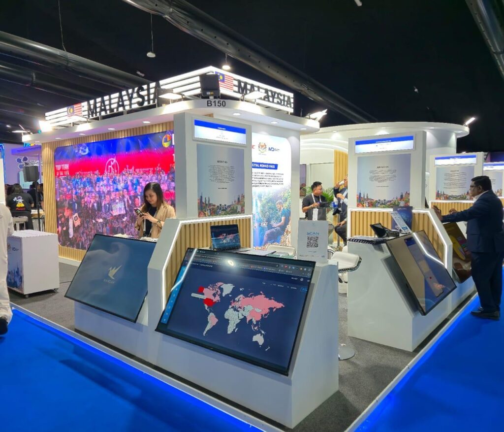 Malaysia Digital trade show booth featuring interactive kiosks, digital displays, and LED wall.