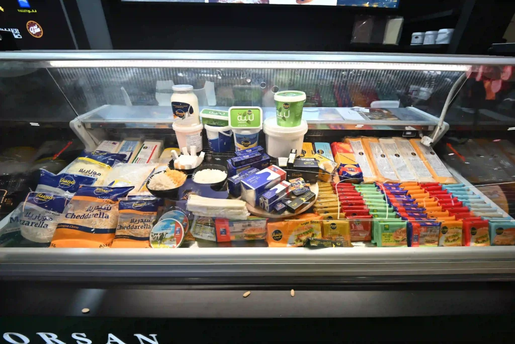 Close-up view of packaged food products displayed inside a refrigerated exhibition counter.