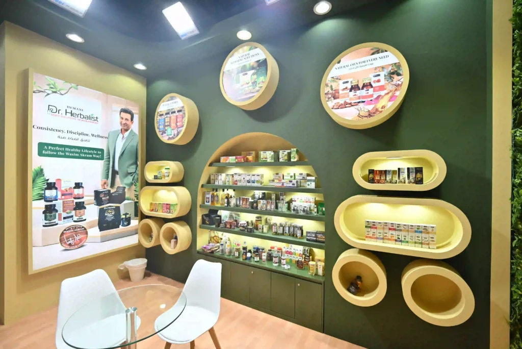 Trade show booth interior featuring circular product displays and illuminated shelving