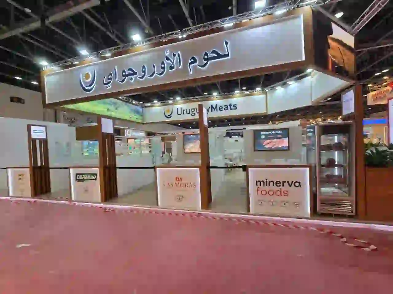Uruguay Meats trade show booth featuring illuminated signage and branded product displays