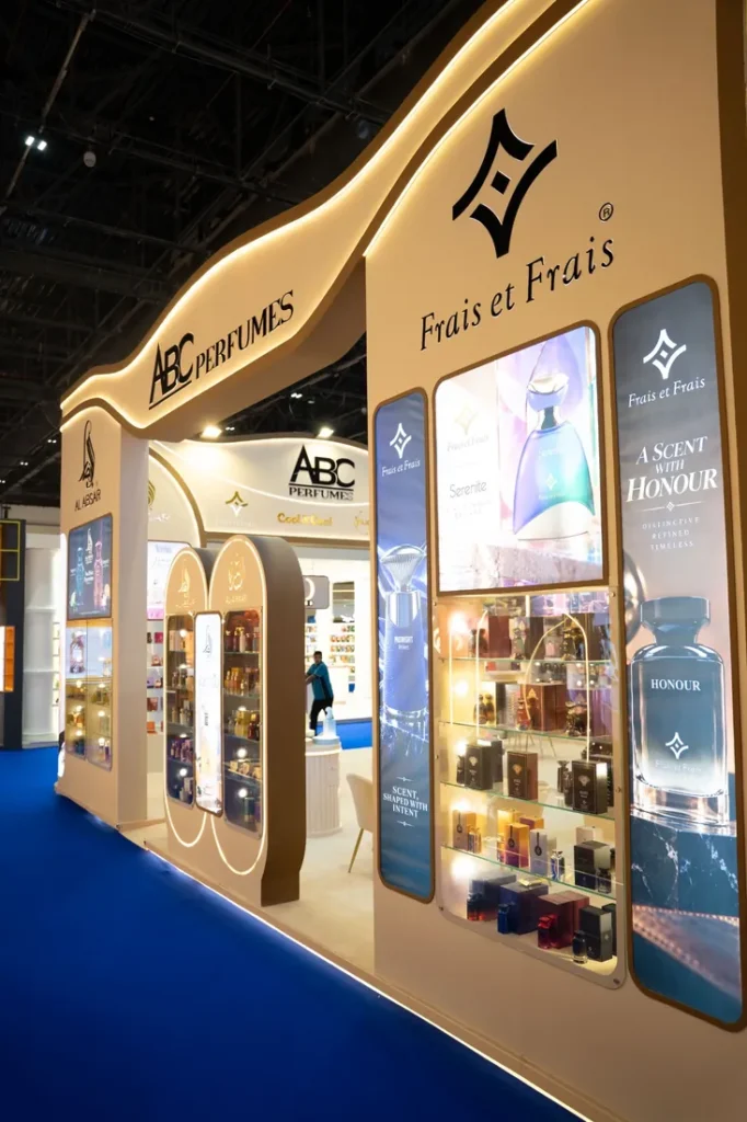 ABC Perfumes exhibition booth featuring curved illuminated signage and fragrance product displays.