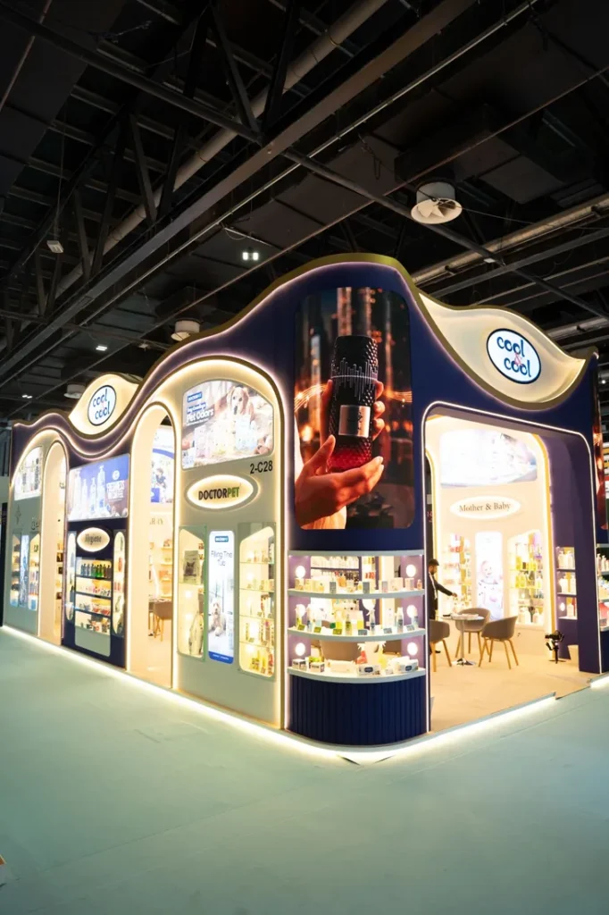 Cool & Cool exhibition stand interior featuring illuminated product displays and curved architectural panels