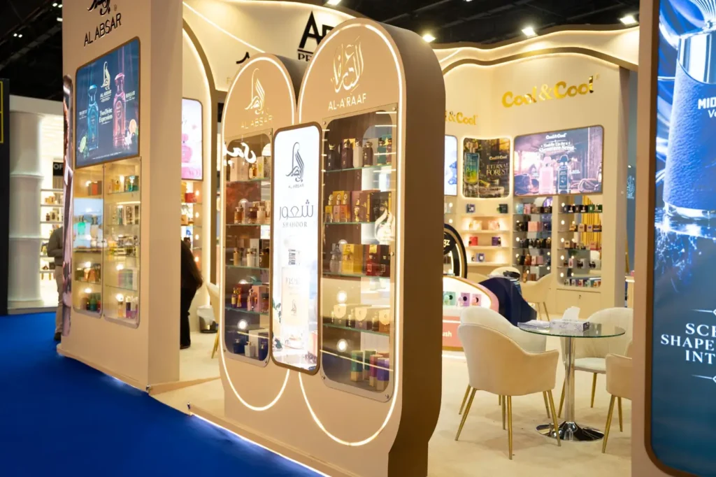 Cool and Cool exhibition display featuring fragrance bottles on illuminated wall shelves.