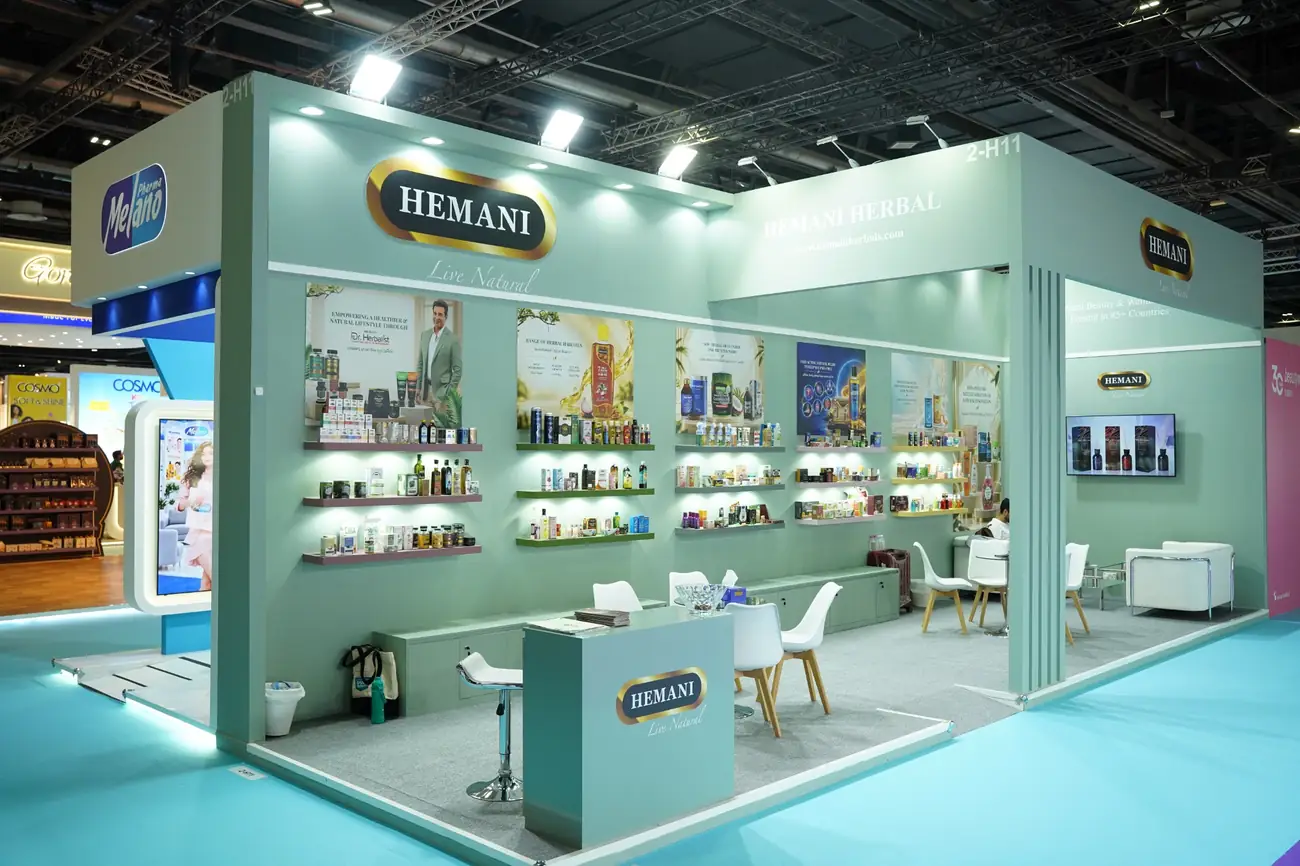 Hemani Herbal exhibition stand with illuminated shelves and a mint green architectural design