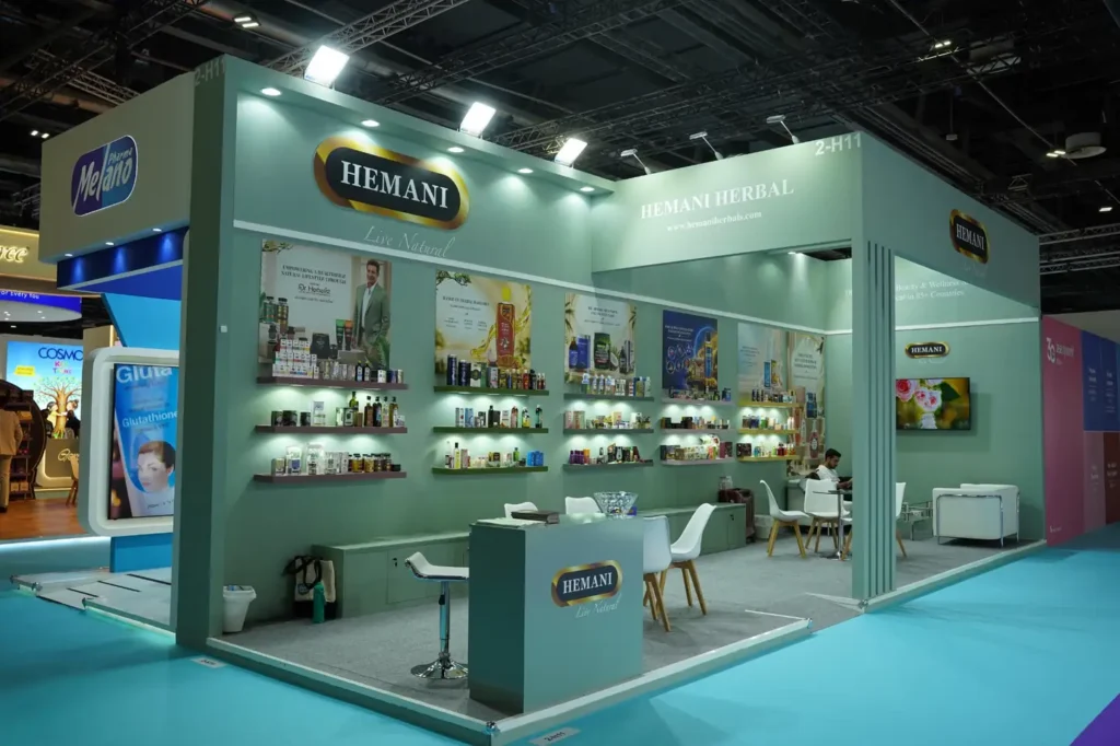 Wide view of Hemani Herbal exhibition booth with product displays and turquoise flooring
