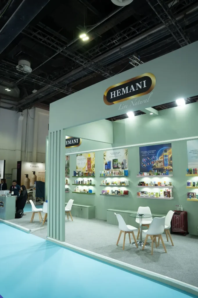 Hemani Live Natural exhibition booth showcasing herbal products in a green display area