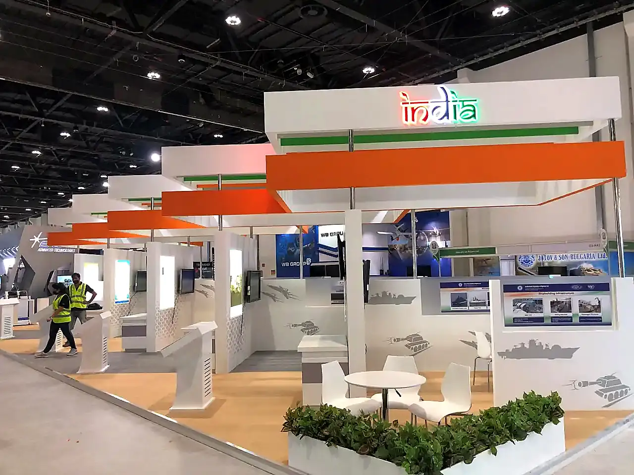 India exhibition stand featuring defense displays, illuminated signage, and visitor meeting areas.
